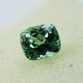 Natural 9.00 carat cushion-cut bluish-green sapphire.